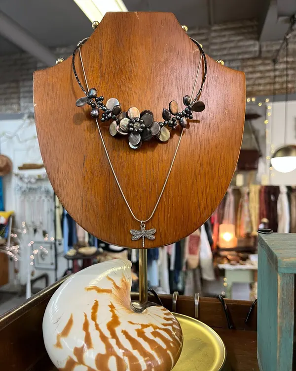 Beaded necklace on a wooden display