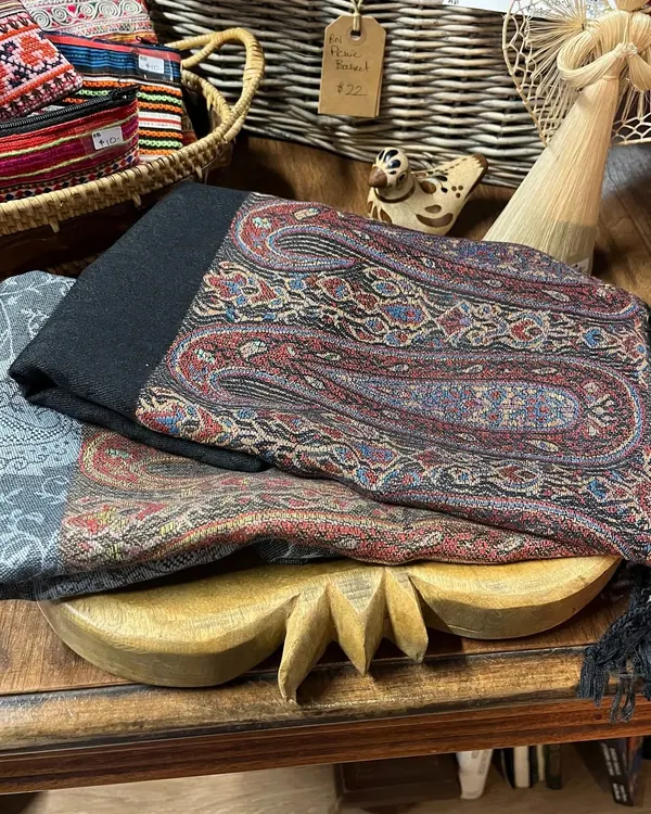 Folded wool and paisley scarves