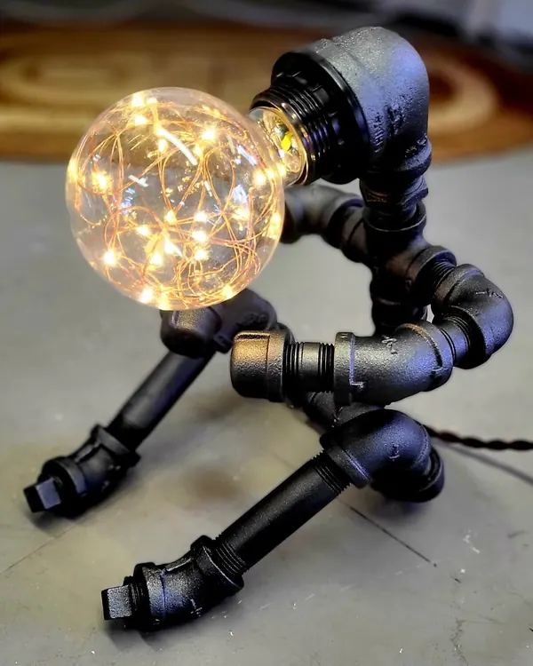 Industrial pipe lamp with a globe bulb