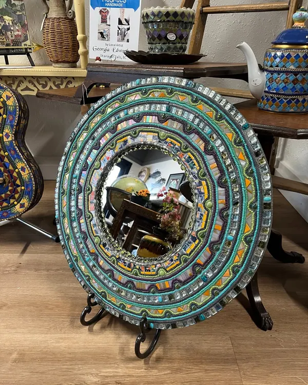 Round mirror in a mosaic frame