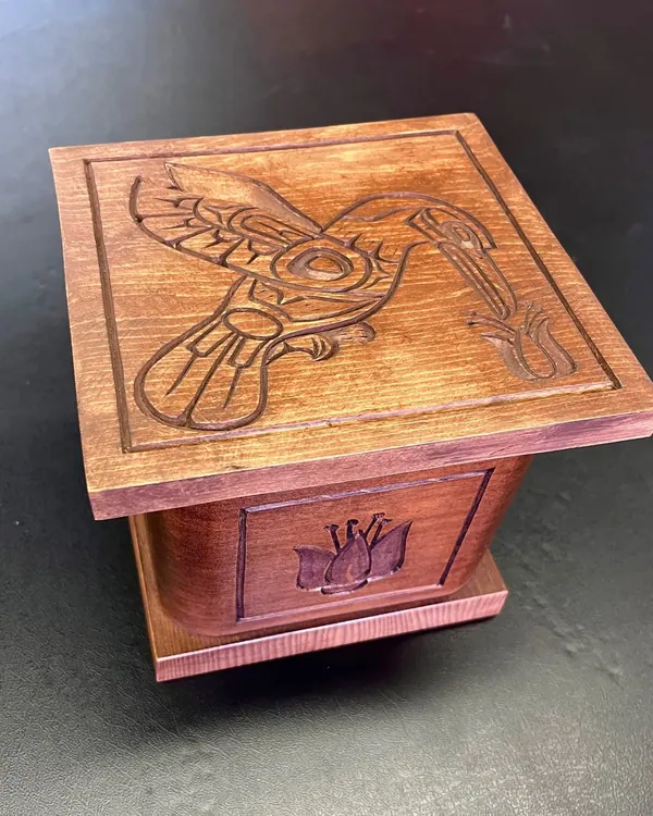 Carved wooden box with a hummingbird lid
