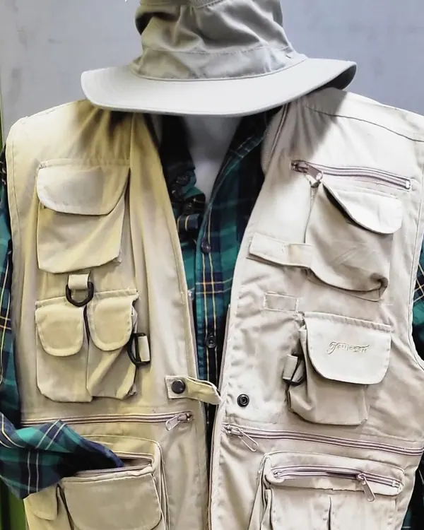 Utility vest and hat over a plaid shirt