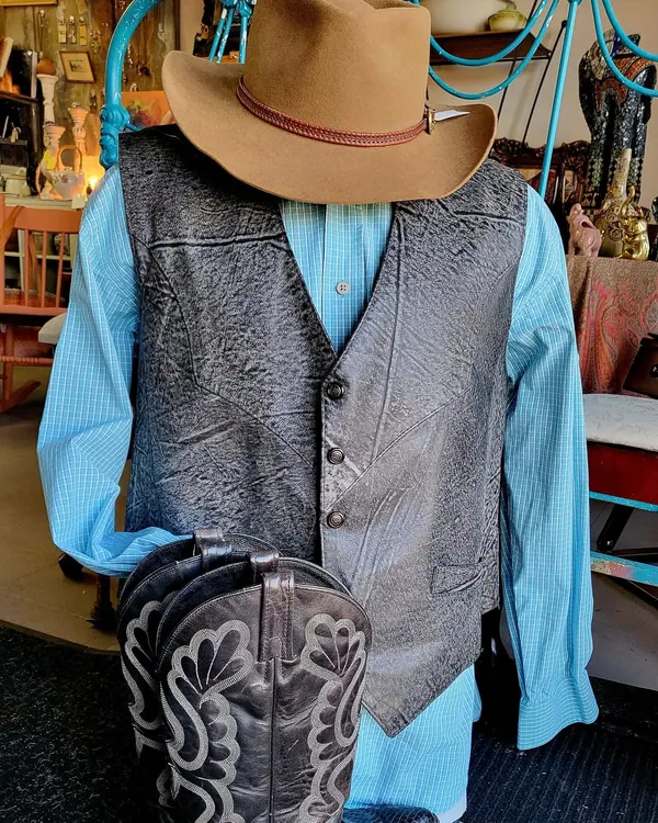 Mannequin in a cowboy hat, waistcoat and denim shirt