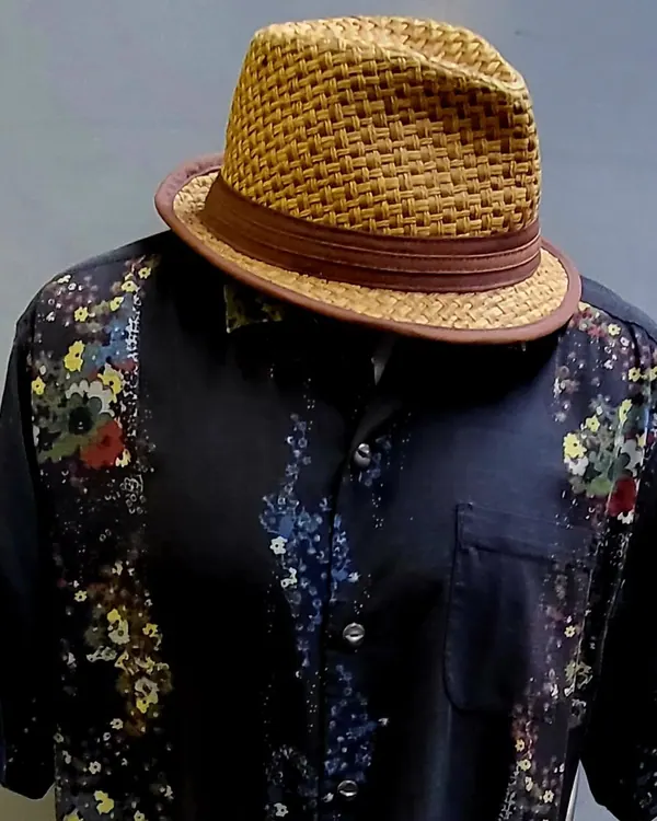 Patterned party shirt with a straw fedora
