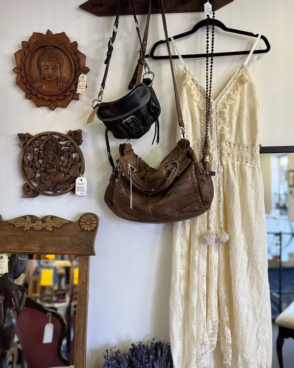 Lace dress, hats and a leather bag on the wall